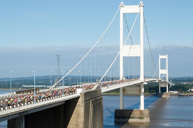 Crowds running in the Severn Bridge Half Marathon, as an illustration of the brain drain affecting higher education in Wales.
